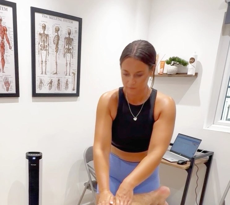 Danni Barriball giving a sports massage in her Exeter clinic